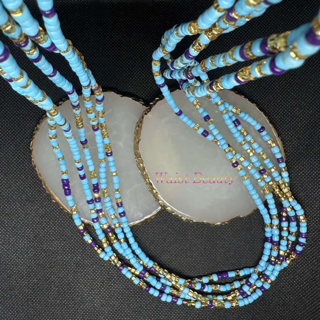 A close-up image of a tie-on waist bead with light blue, purple, and gold beads, arranged in a stylish pattern.