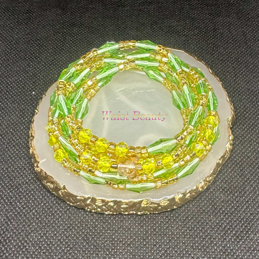 Gold, lime green, and yellow tie-on waist bead from Waist Beauty, adding a pop of vibrant color to your ensemble.
