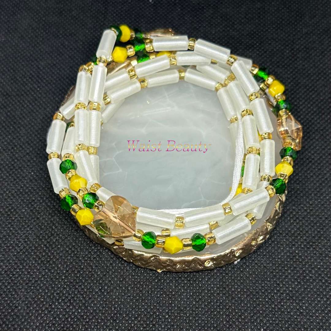 A glow-in-the-dark tie-on waist bead in vibrant yellow, green, white, and gold hues, perfect for adding a pop of color to your ensemble.