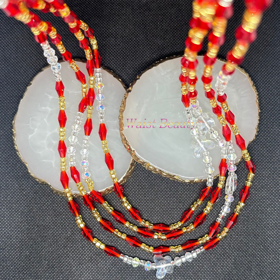 A stunning waist bead featuring red, gold, and clear beads, adding a touch of elegance and sophistication to any outfit.