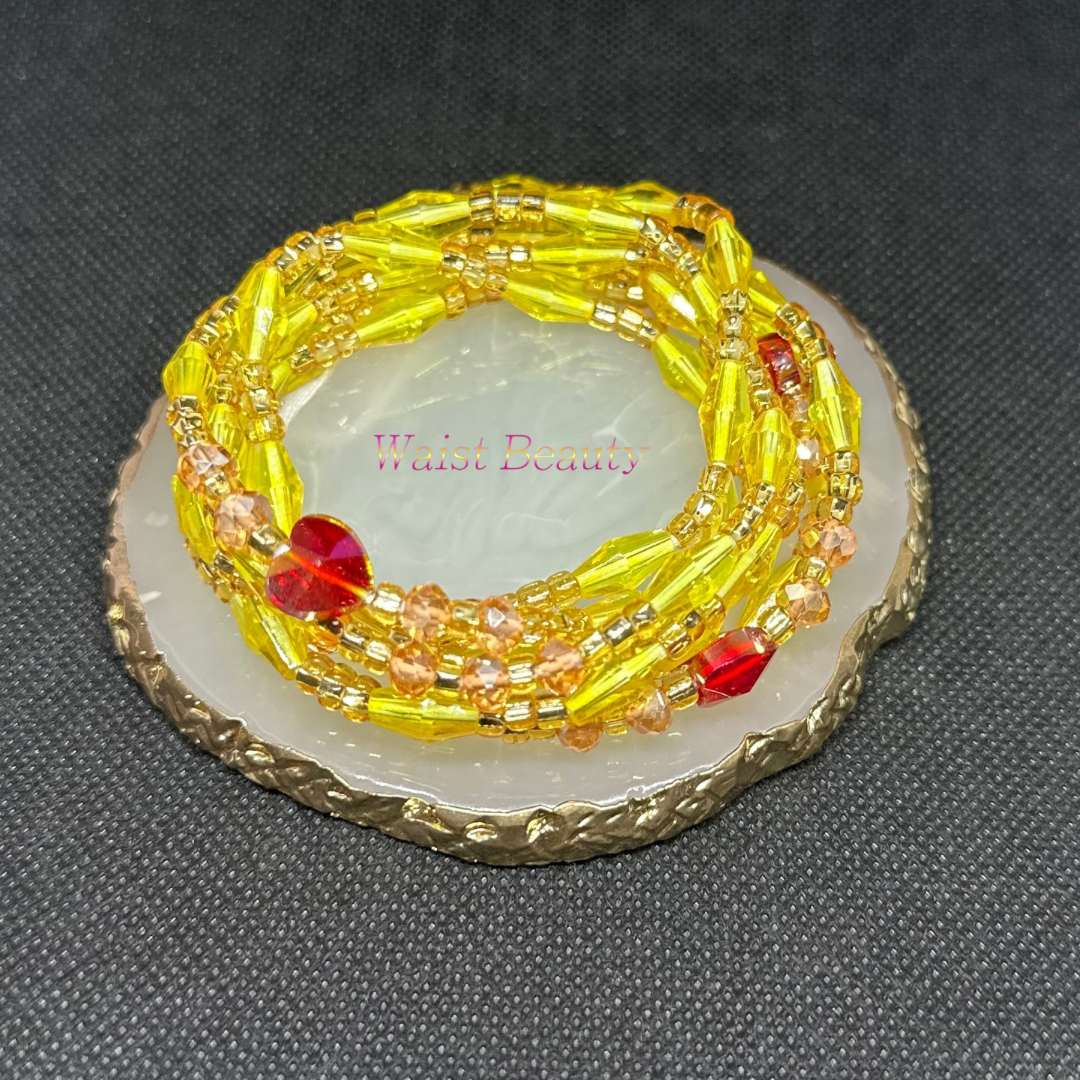 Yellow, gold, and red waist bead from Waist Beauty, radiating warmth and vibrancy with its rich hues. Handcrafted to perfection, this accessory adds a touch of elegance and style to any outfit.