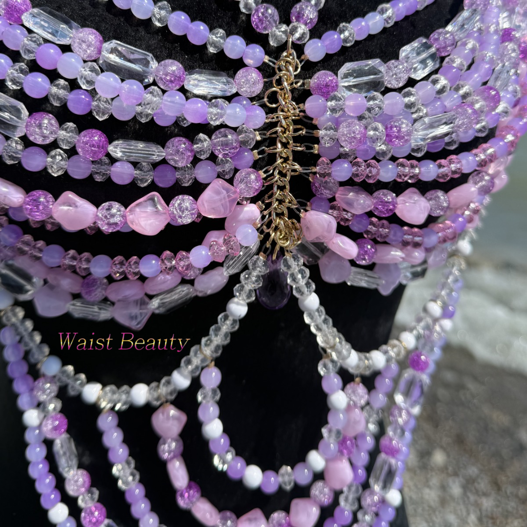 Waist beauty - Intricate purple and lavender crystal beaded body chain top with a cascading midriff drape on a black mannequin by the sea.