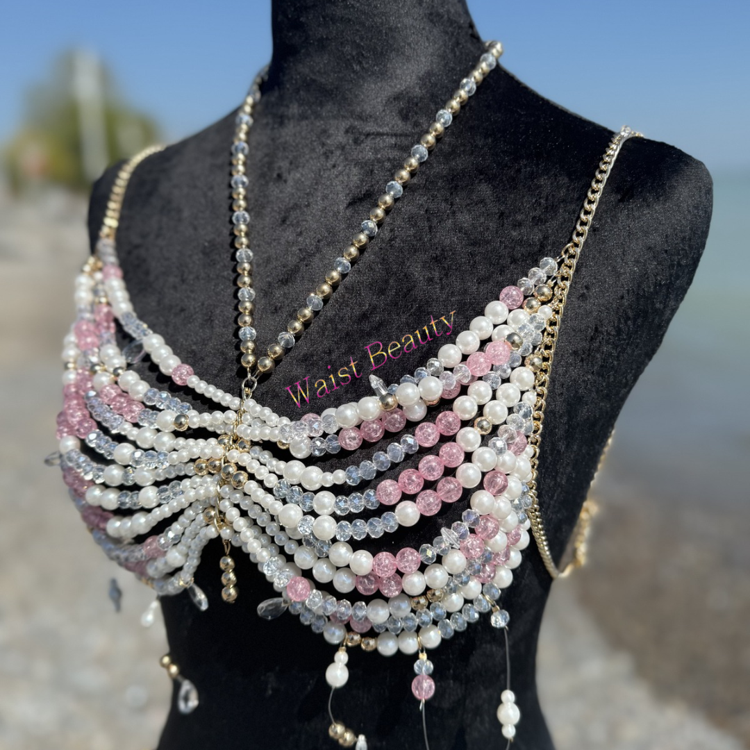 Waist beauty - White and blush pink pearl butterfly-shaped beaded body bra with gold chain accents on a mannequin.