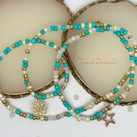 this is a gold, cream, white and blue elastice waist bead by Waist Beauty
