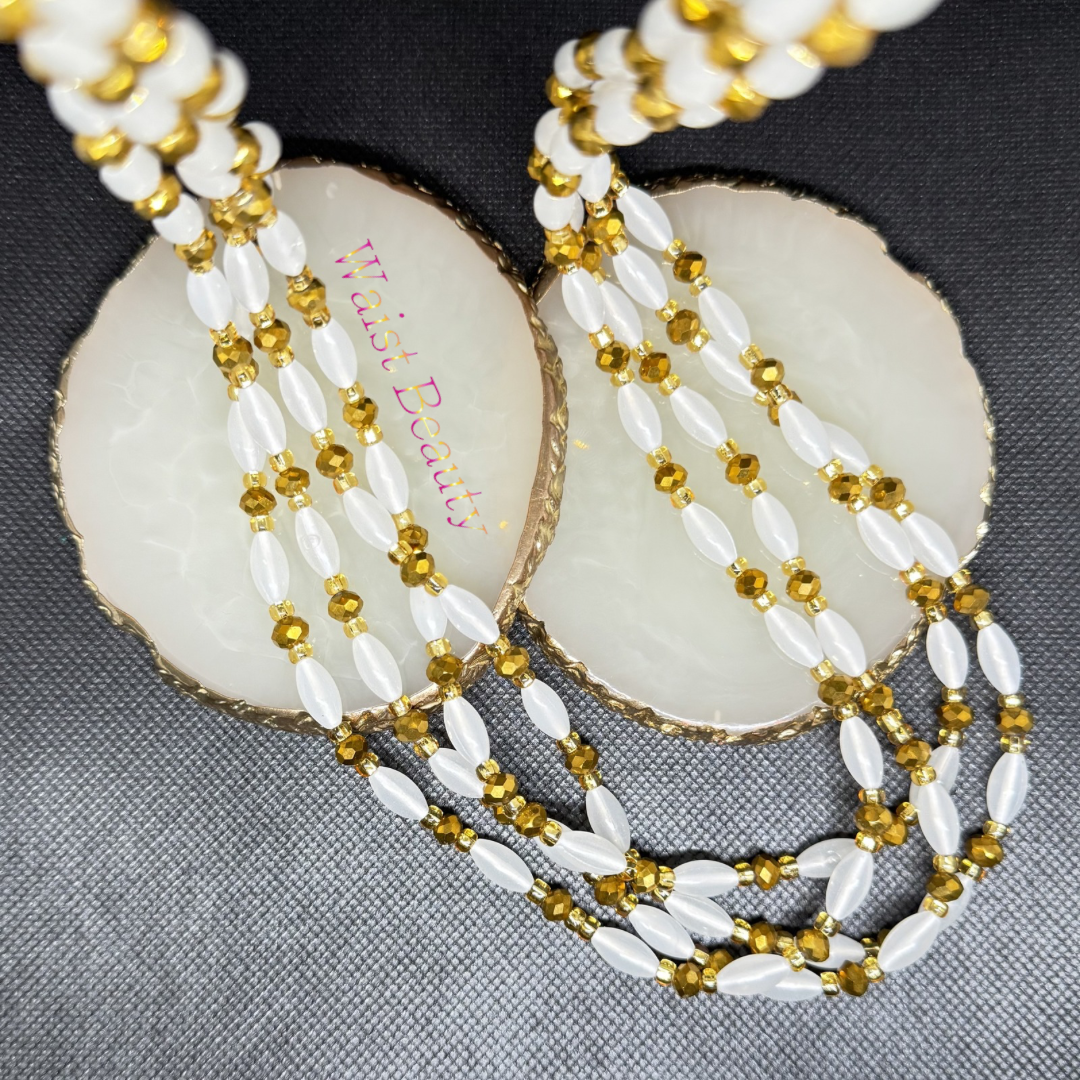 Waist beauty - Embody pure luxury, health, and wealth with the Golden Goddess tie-on waist beads. Simple yet incredibly striking, this monochromatic strand alternates soft, glowing opalescent white rice beads with brilliantly reflective, faceted metallic gold crystals. It provides a sophisticated look that pairs seamlessly under or over any outfit. Measures 53 inches for an adjustable, perfect-for-you fit that celebrate your divine femininity.