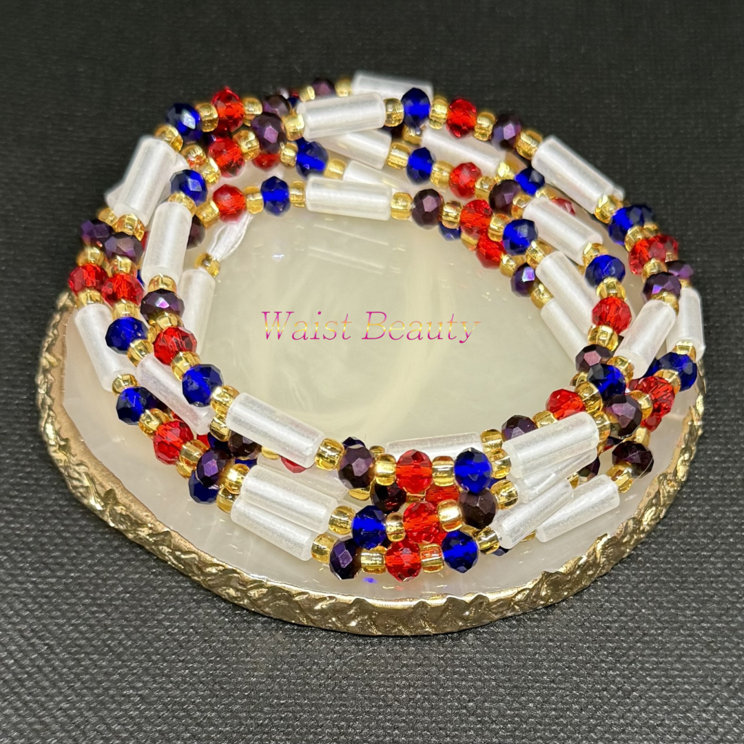 Command attention and exude pure confidence with the cosmic fire tie-on waist beads. Featuring frosted white cylinder beads structured between clusters of rich royal blue, fiery crimson, and regal deep purple crystals, this strand is the definition of a statement piece. It beautifully blends meanings of passion, royalty, and wisdom. This 53-inch non-stretch strand is custom-crafted to sit beautifully at your waist or low on your hips.